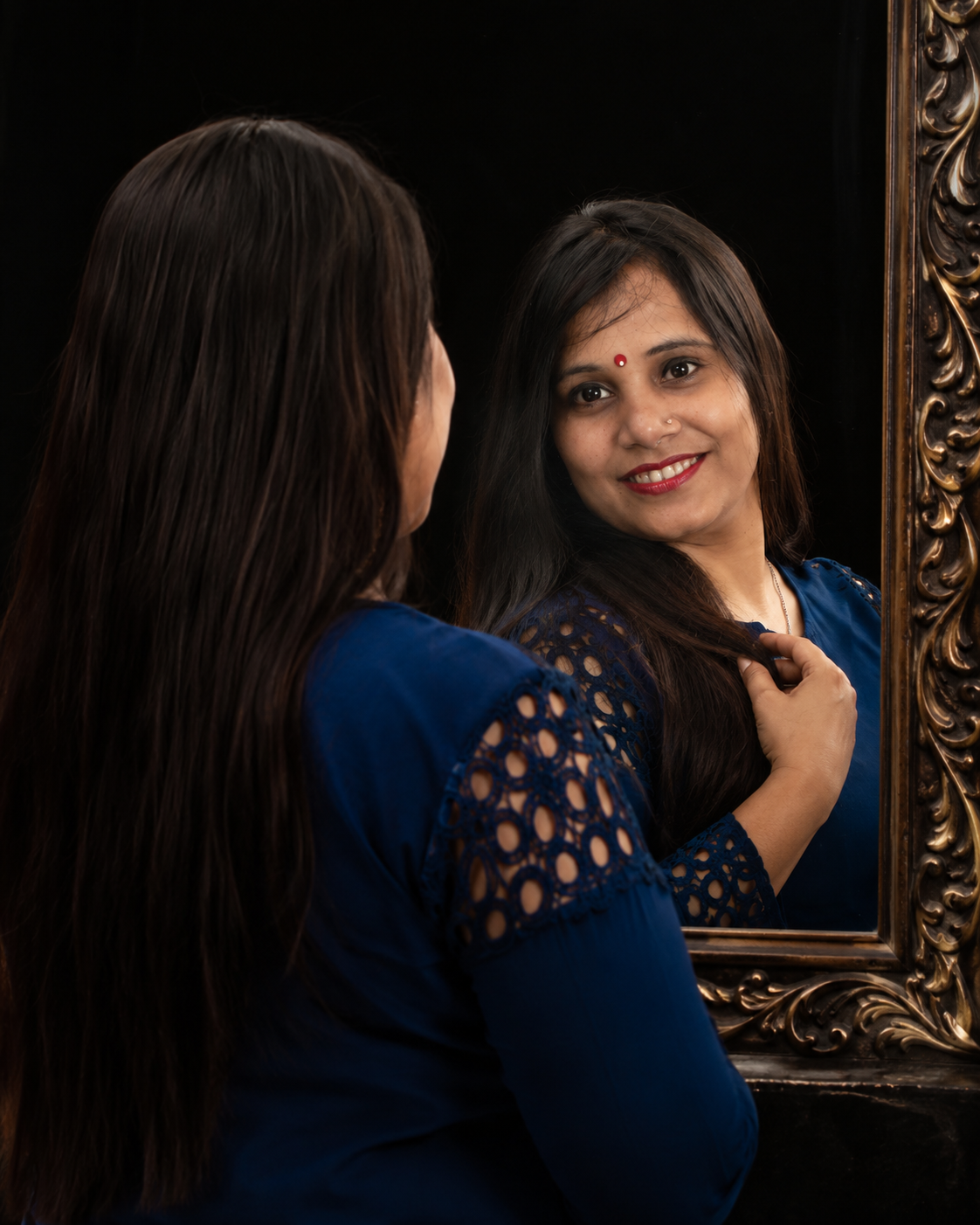 beautiful young woman looking into a mirror